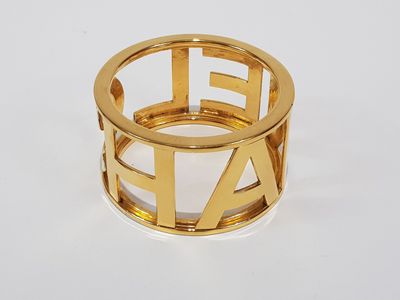 an image of a gold ring with the letter e on it