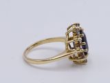 an image of a gold ring with a blue stone in the center