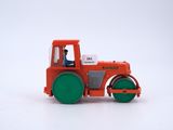 a red toy tractor with a green wheel on a white surface