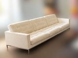 a white couch sitting on a table in a living room