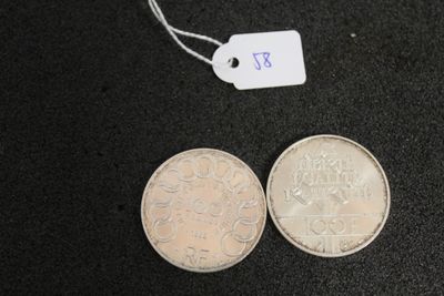 two coins that are next to each other on a table