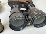 an old pair of binoculars sitting on top of a table next to a skull
