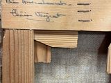 a picture of a picture of a wooden frame with writing on it