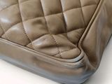 a close up of a brown leather bag with a zipper