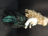 a doll that is laying down on a black surface