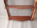 a wooden shelf that has two shelves on top of it