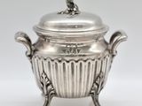an antique silverplated bowl with a lid on a stand