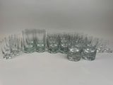 a group of glasses sitting on top of a table next to each other