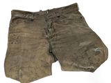 an old pair of brown pants with a hole in the side