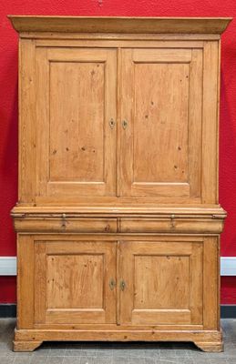 an image of a wooden cabinet against a red wall