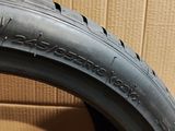 a close up of a tire on a cardboard box with a cardboard box in the background