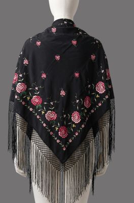 a black shawl with pink roses and fringes on it