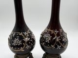 pair of vases on stand on white background with white background