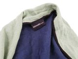 the back of a blue and green jacket with a label on it