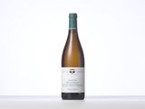 a bottle of white wine sitting on top of a table