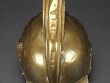 brass fire helmet on a black background