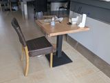 a table with two chairs and a bench in the middle of the room