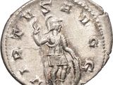 a silver coin with a man holding a staff and a sword