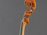 a close up of a violin on a stand against a gray background