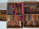 boxes of old books are stacked on top of each other on a table