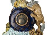 a figurine of an angel and a clock on a table