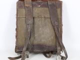an old brown leather backpack with straps on a white background
