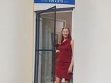 an image of a woman in a red dress standing in front of a glass door