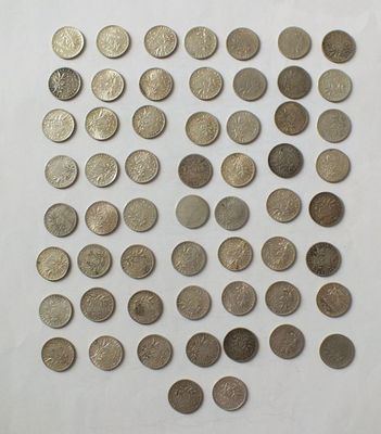 a bunch of coins sitting on top of a white surface