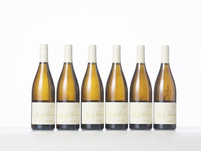 six bottles of wine lined up in a row on a table
