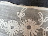 a close up of a pillow with a flower design on it