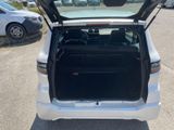the back of a white car with its trunk open in a parking lot