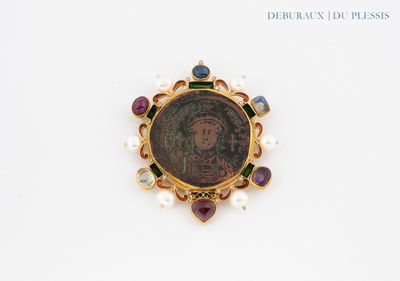 an image of a gold broochle with a picture of a woman on it