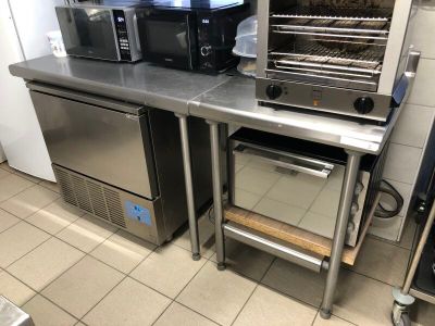 stainless steel counter top with oven, microwave, and toaster on it