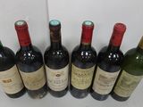 six bottles of wine are lined up in a row on a table