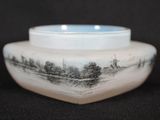 a white bowl with a picture on it on a black background