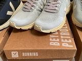 three pairs of new balance running shoes are on display in a box