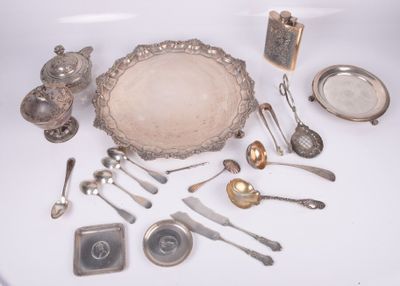 a lot of silverware on a white table