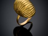 a close up of a gold ring on a black surface