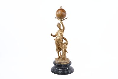 an image of a statue of a woman holding a globe on a stand