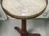 a small table with a marble top on a stand