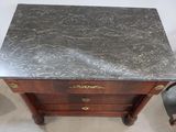 a marble top table with two drawers on top of it