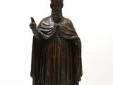 an image of a statue of a man with a hat and robe