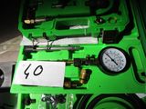 a green box with a gauge and a sign on it