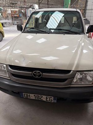 a white toyota pickup truck parked in a garage