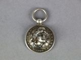 a close up of a silver coin with a woman on it