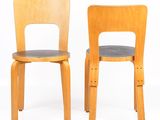 two wooden chairs that are sitting next to each other