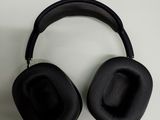 a pair of black headphones sitting on top of a table