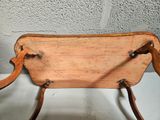 a small wooden chair with a wooden seat on a table