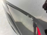 a close up of a car ' s front bumper with scratches on it