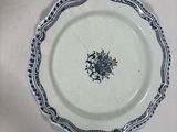 a blue and white plate with a blue flower on it